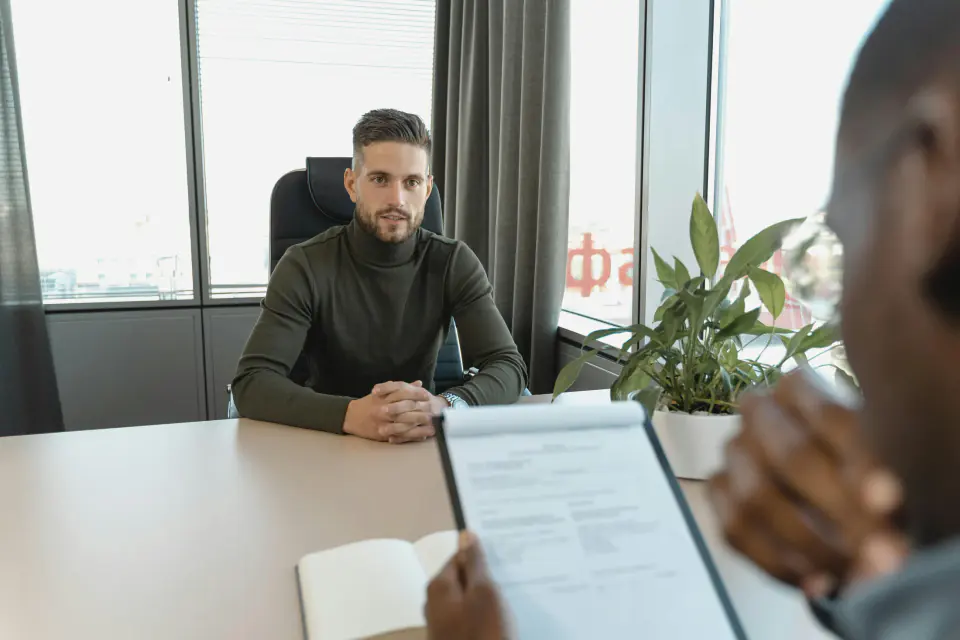Two professionals discussing a recruitment mandate in a business setting