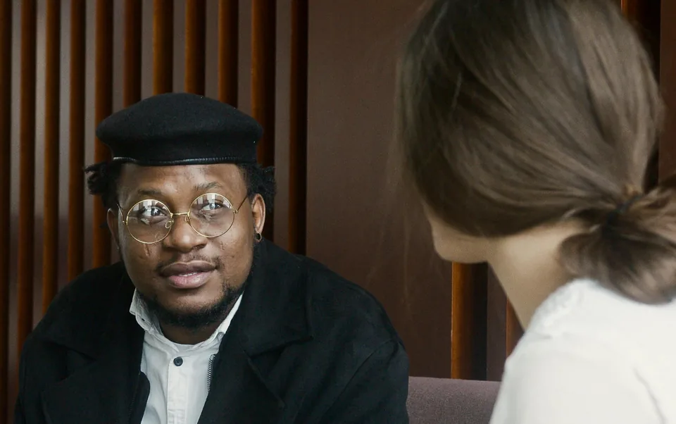 Professional discussing a mandate with a consultant in an office