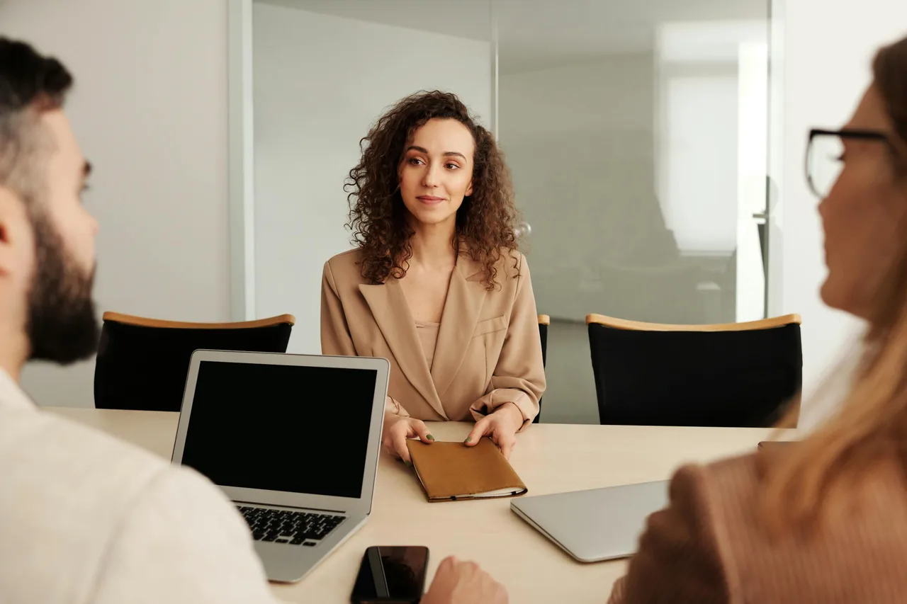 Professional woman in an interview with two people in a meeting room